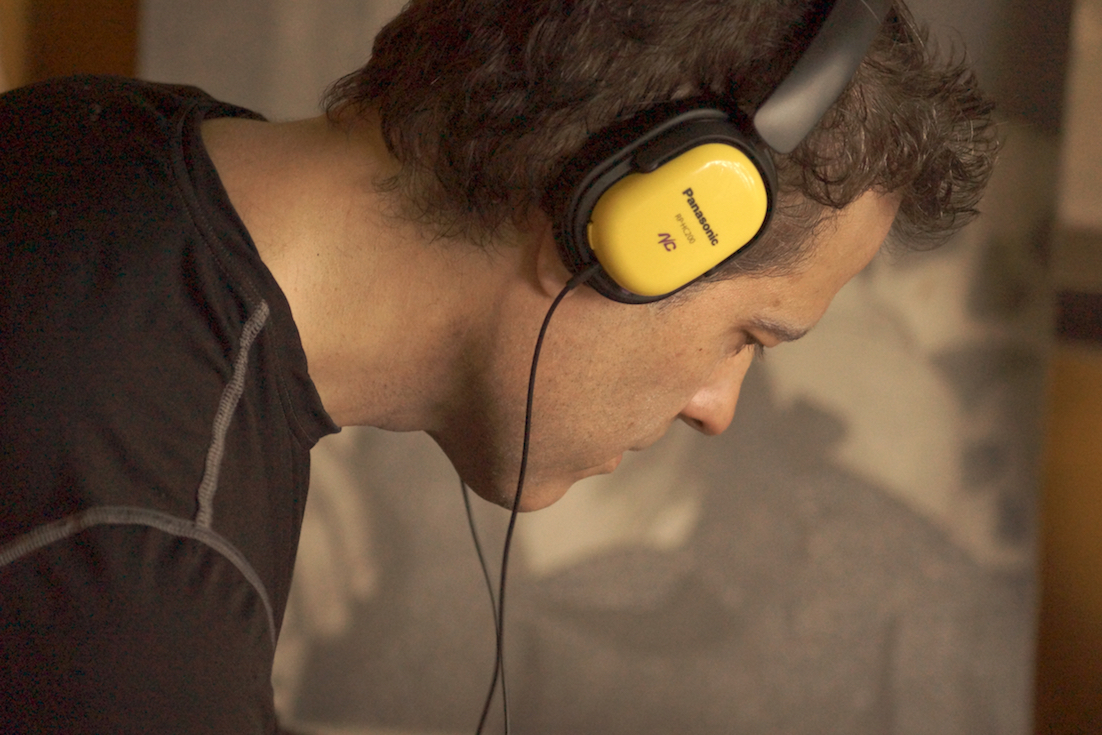 Ian Brennan wearing yellow headphones.