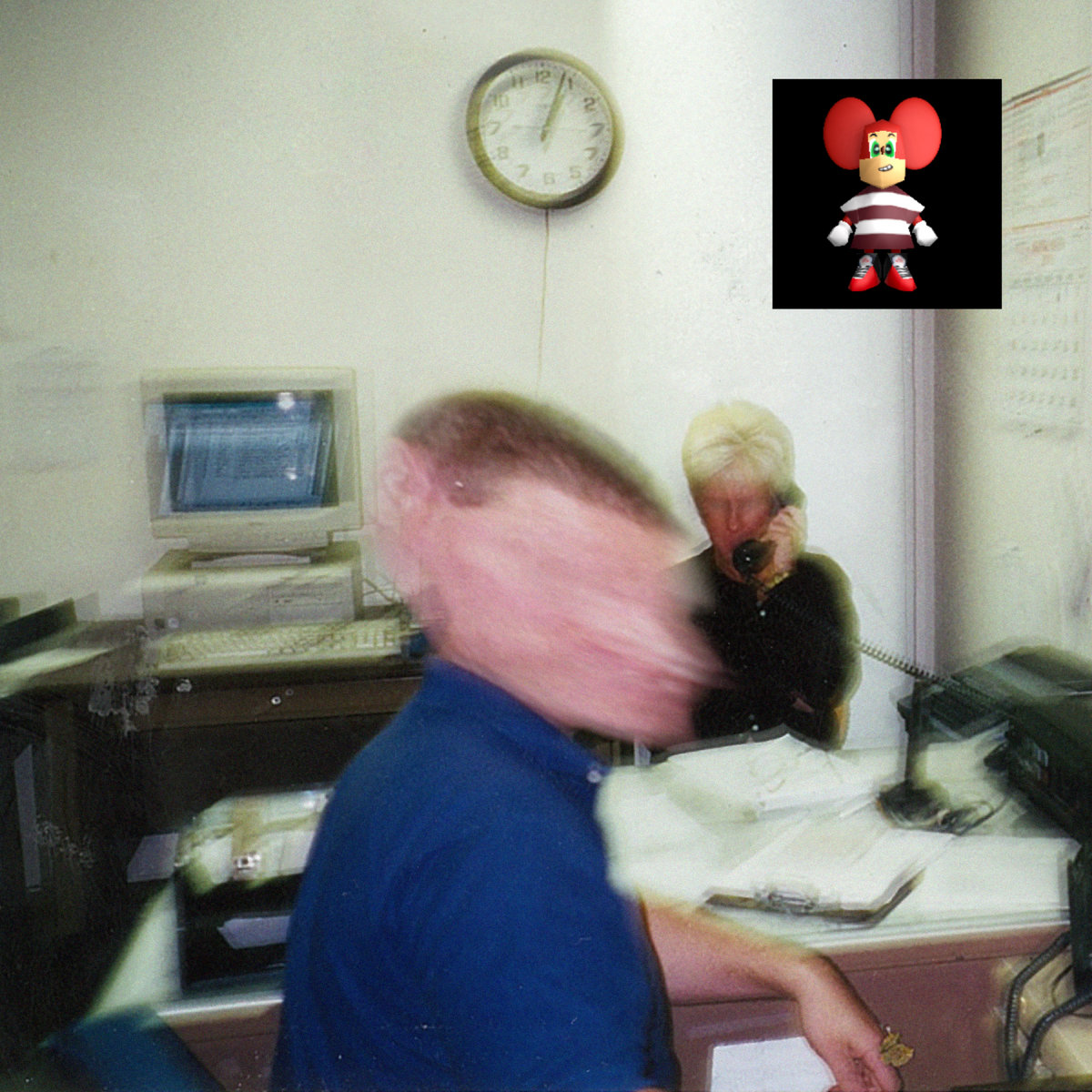 Two blurred face people sitting in an office with an old computer in the background.