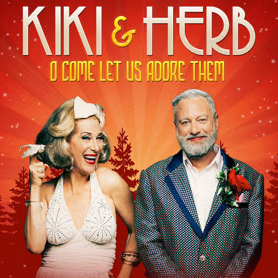 Kiki & Herb standing next to each other with a red tree line in the background.