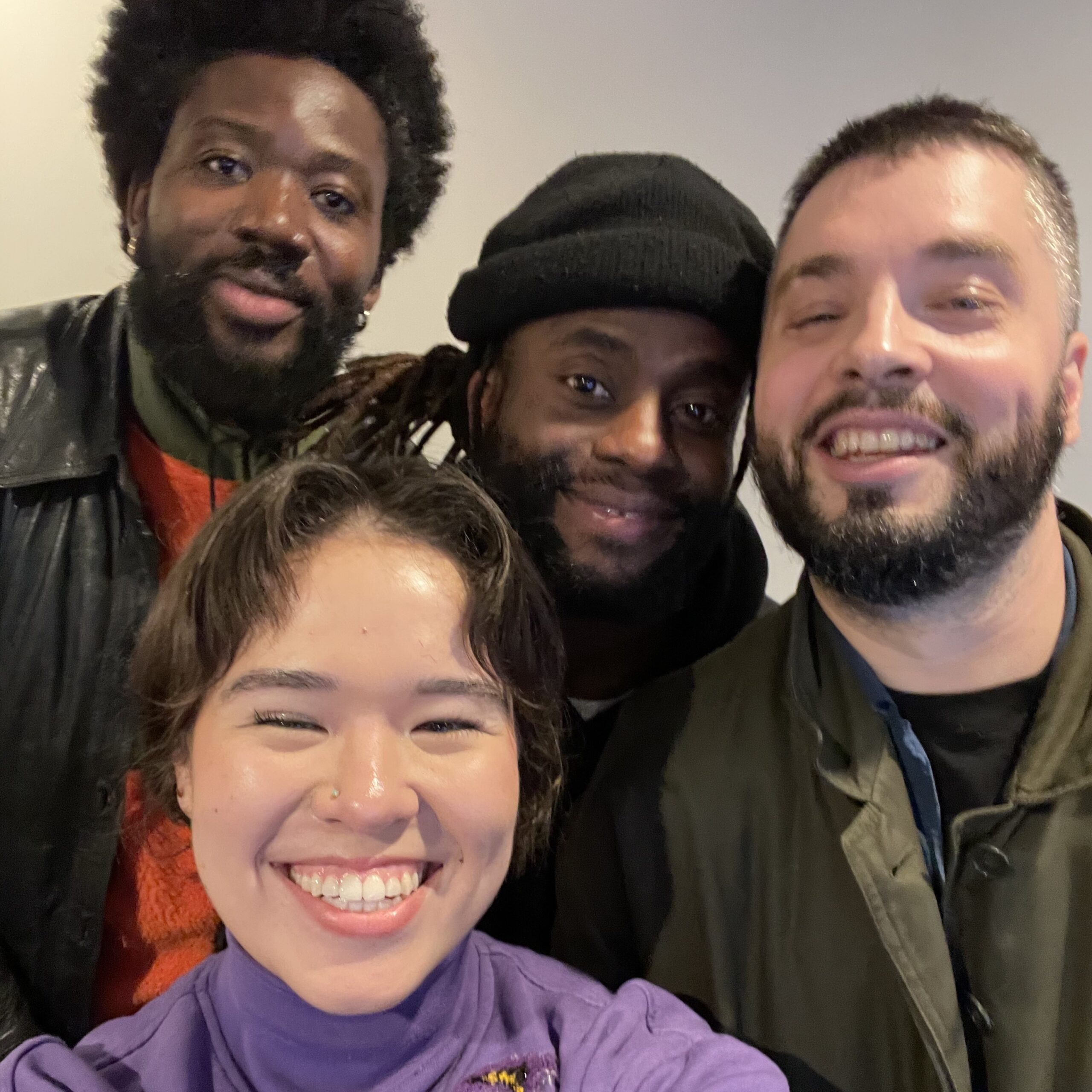 Three members of Young Fathers with KALX DJ, Dokkaebi. Everyone is smiling!