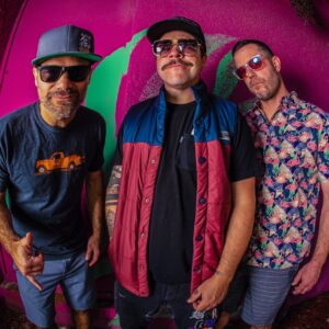 Three members of Badfish standing together with a fisheye lens effect.