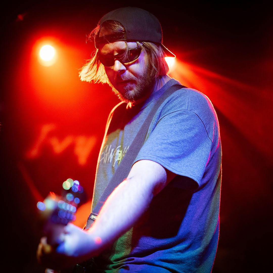 Musician playing electric guitar on stage