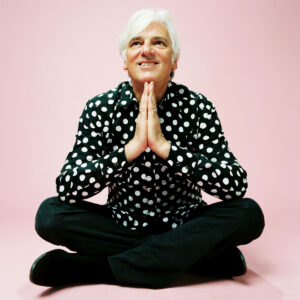 Robyn sitting on the floor in a pink room.