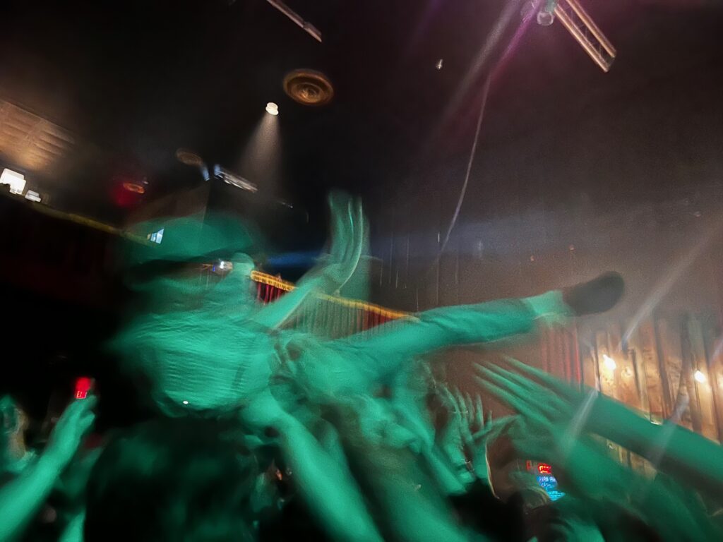 A blurred crowd surfer in a theater