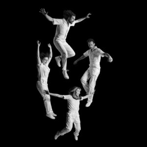 Band floating in front of black background.