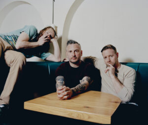 Bear Hands, the band, sitting around a restaurant booth