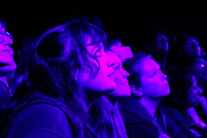 A crowd at the front row of The Independent looking up at the stage