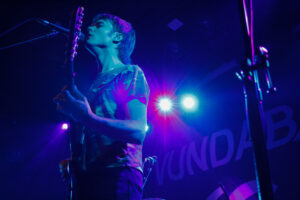 Vundabar's Brandon Hagen singing, playing guitar on stage