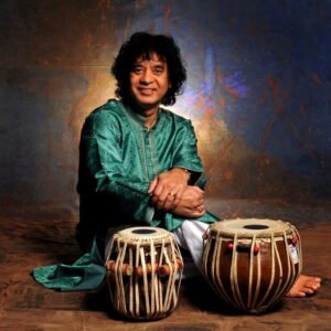 Zakir Hussain sitting with his tablas.