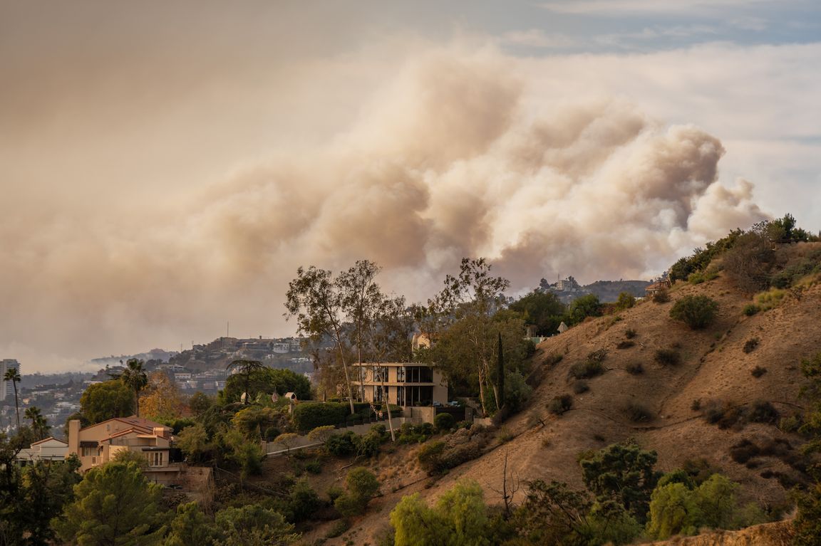 Wildfire smoke is seen billowing over the LA hills.