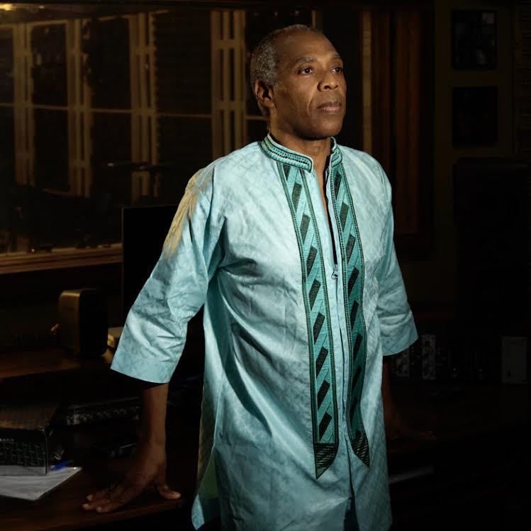 Femi Kuti standing in colorful outfit.