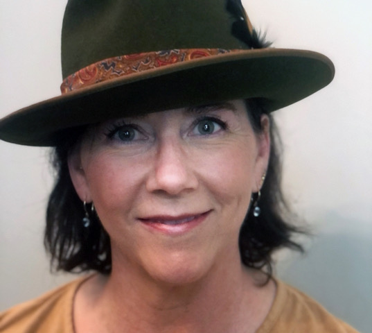 Headshot for Amelia Davis wearing a hat
