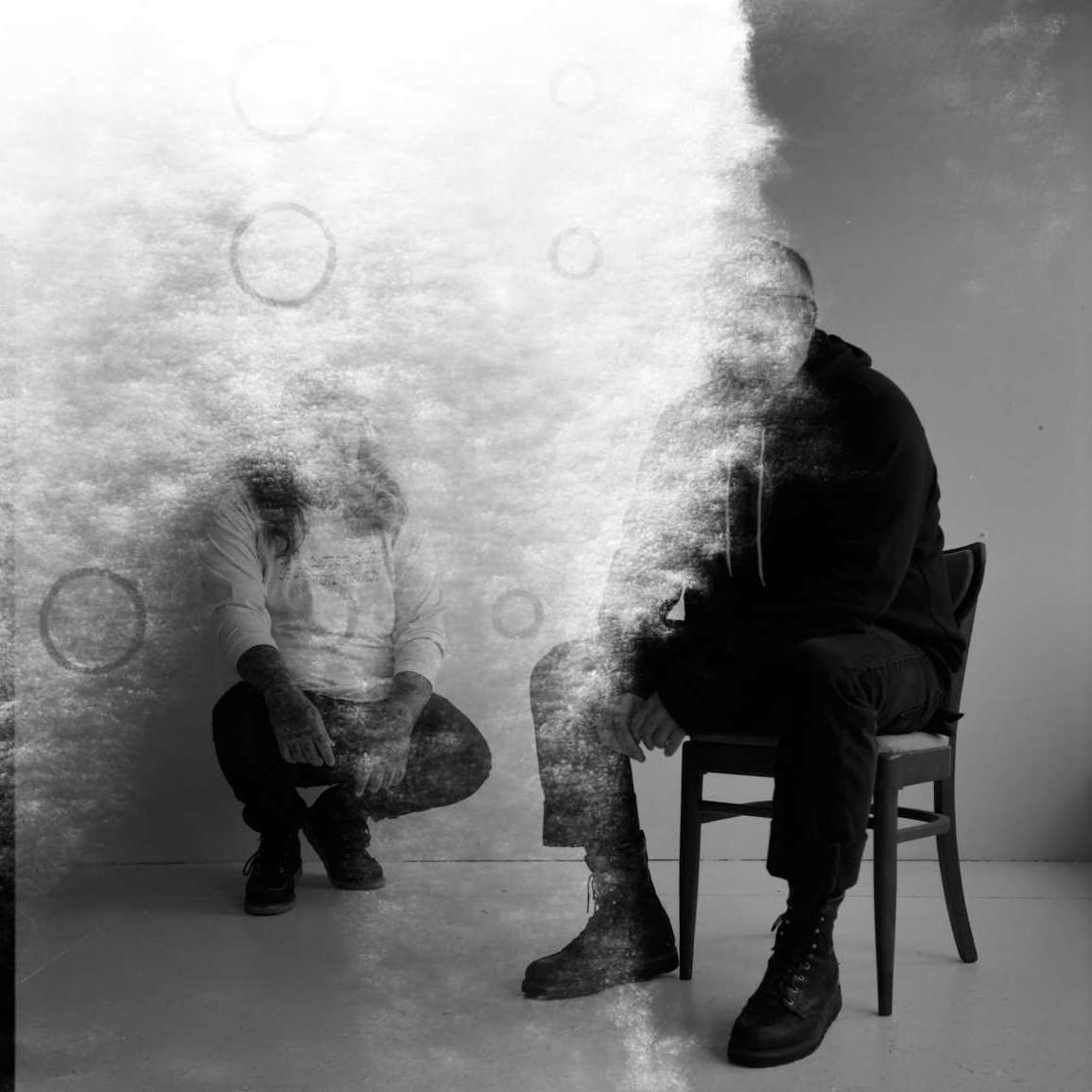 Members of The Body sitting in a smoke filled room.